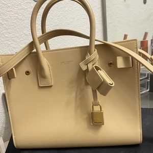 SAINT LAURENT
Beige Classic Baby Sac De Jour Tote in beige color.